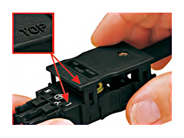 Put the connector in which connections of the wires were made in the strain relief housing so that the TOP surface matches.
